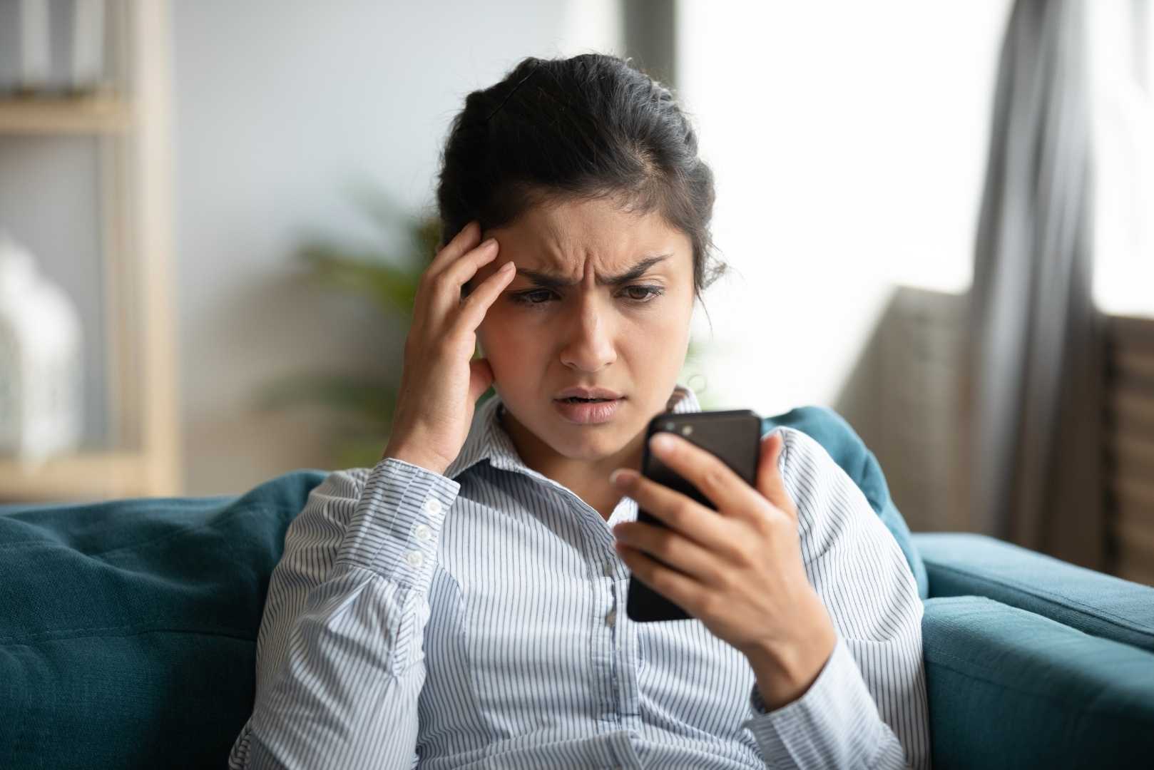 Frustrated girl feels stressed with cellphone problems